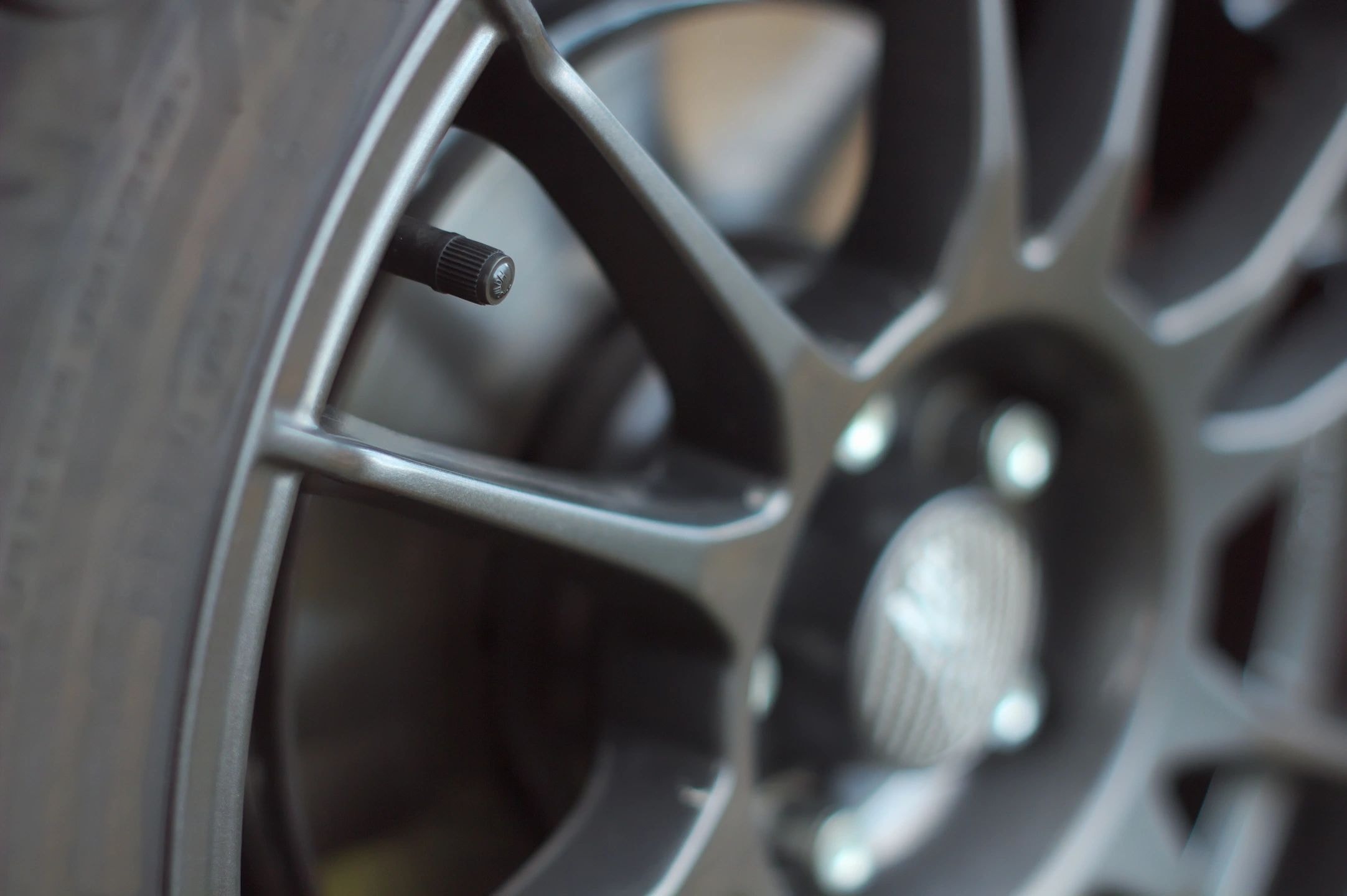 Close-up of a dark alloy wheel rim with shallow depth of field
